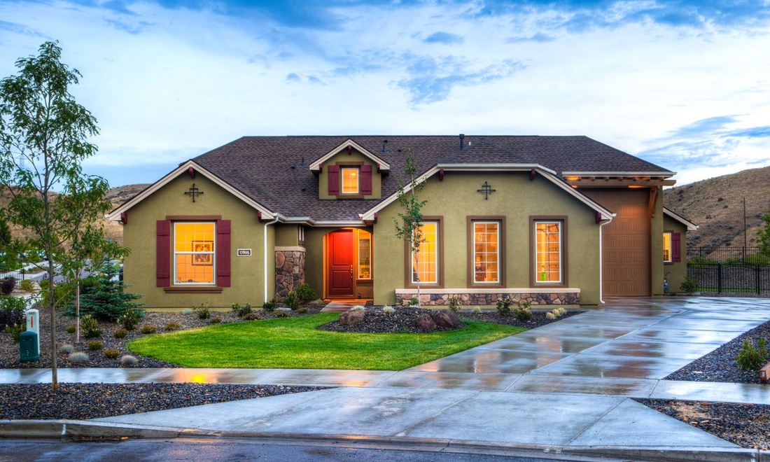 A suburban home exterior with siding, stone and replacement windows